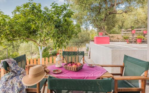 a table with a basket of fruit on a patio at Domus Lukas Apartments in Marathias
