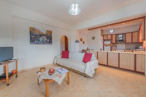 a living room with a couch and a kitchen at Domus Lukas Apartments in Marathias