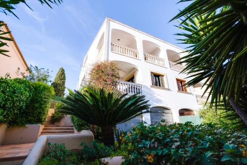 a large white building with plants in front of it at VILLA BONANOVA by Priority in Palma de Mallorca