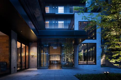 an external view of a building with a hallway at Bespoke Hotel Shinsaibashi in Osaka