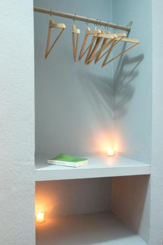 a shelf with two lights and a book on it at Pensión San Marcos in Arcos de la Frontera