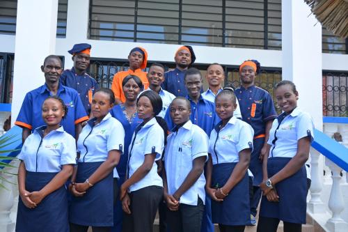a group of people in uniforms posing for a picture at Ocean View Nyali Boutique Hotel in Nyali