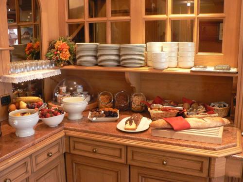 a kitchen counter with a bunch of food on it at Hôtel Le Mittelwihr in Mittelwihr