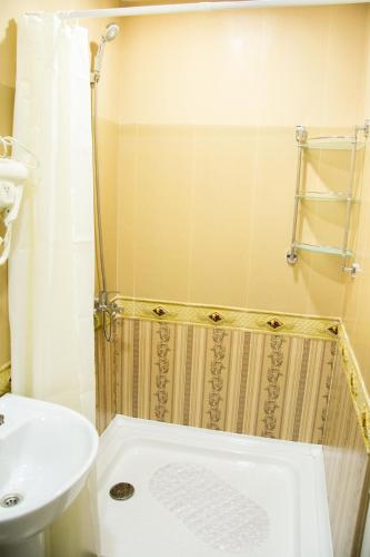 a bathroom with a sink and a toilet and a shower at Apartments Of Aurumi in Tbilisi City