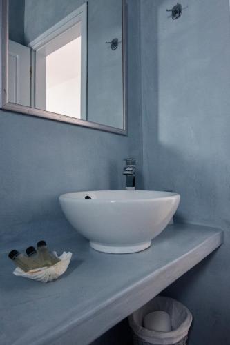 a white sink on a counter in a bathroom at Calderimi Apartments in Fira