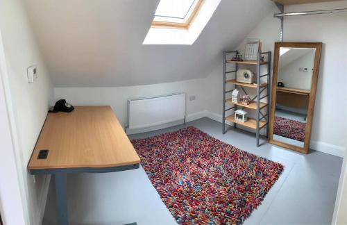 a small room with a table and a rug at Primrose Place Portrush in Portrush