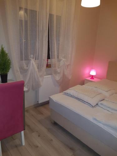 a bedroom with two beds and a window at Willa Nad Potokiem in Kudowa-Zdrój
