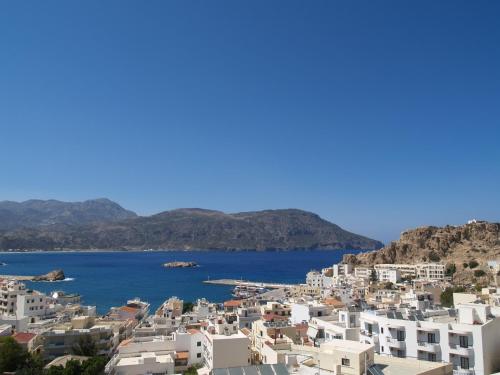 a view of the town of positano and the ocean at Roses Studios in Karpathos Town
