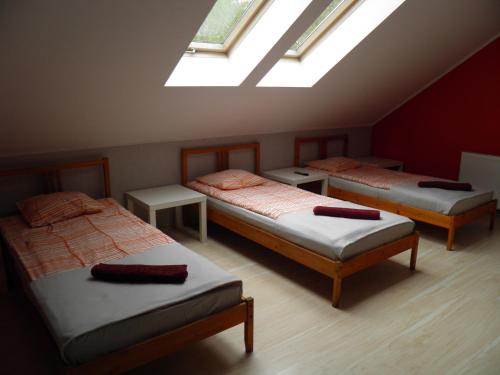 3 łóżka w pokoju z sufitem ze świetlikami w obiekcie Marianki w mieście Dąbrowa Górnicza