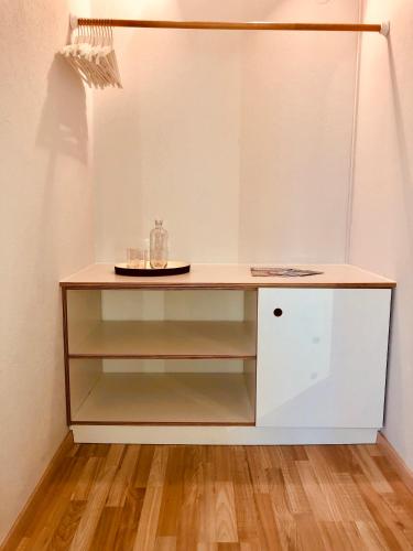 a white cabinet with a counter top in a room at Hotel Sonnenhof - bed & breakfast & appartements in Innsbruck