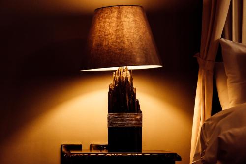 a lamp on a table next to a bed at Ballycannon Lodge in Croagh