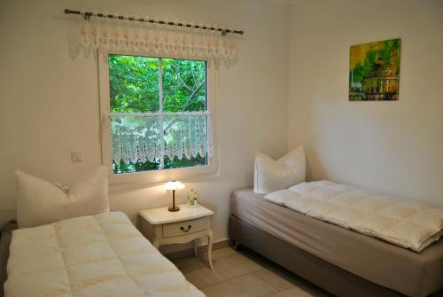 a bedroom with a bed and a window at Ferienhaus Berlin in Blankenfelde
