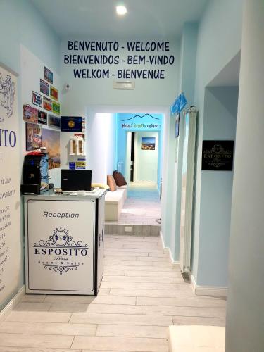 a store with a sign on the floor in a hallway at ESPOSITO PLAZA- ROOMS & SUITE in Naples