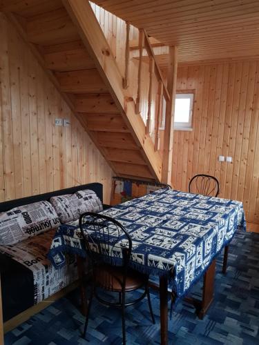 a dining room with a table and a bed in a attic at Cottage in Staraya Russa in Staraya Russa