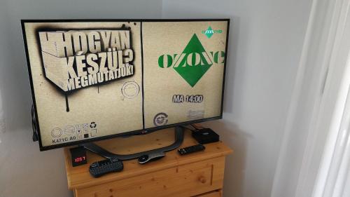 a television sitting on top of a wooden dresser at Anna villa in Lenti