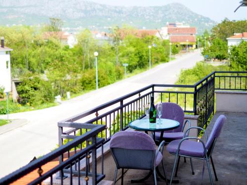 a table and chairs on a balcony with a view at Apartment Ivan-Experience 3 Bedrooms in Ljubuški