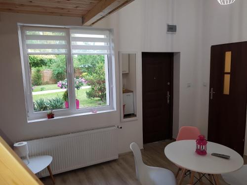 a dining room with a table and a window at Willa Nad Potokiem in Kudowa-Zdrój