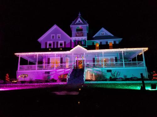 a house is lit up with christmas lights at Hudson Manor Bed & Breakfast in Watkins Glen