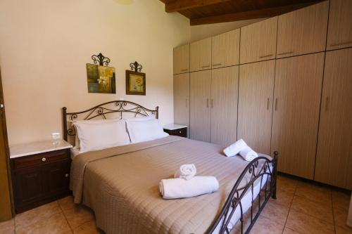 a bedroom with a large bed with towels on it at Villa Ergina in Agios Nikolaos