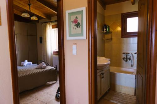 a bathroom with a sink and a toilet and a tub at Villa Ergina in Agios Nikolaos