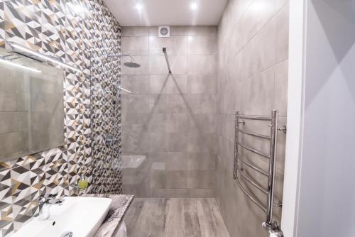 a bathroom with a shower and a sink at Is’land Hostel in Uzhhorod