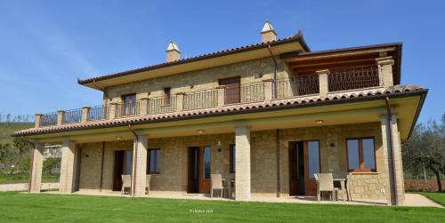 a large house with a balcony on top of it at Il Casale degli Ulivi in Gradoli