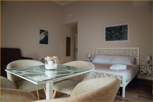 sala de estar con cama, mesa y sillas en Villa Cua en Ercolano