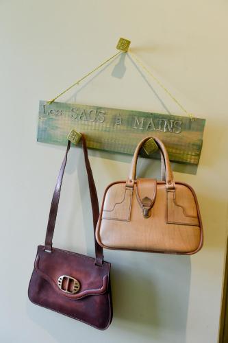 two bags are hanging on a wall at L'EN VERT in Bagnères-de-Bigorre