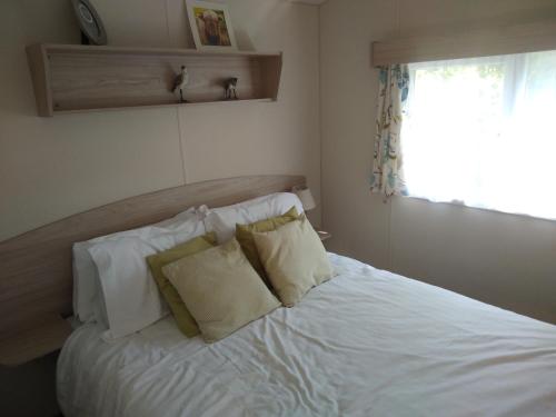 A bed or beds in a room at Borwick Lakes Haven