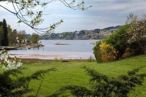 a view of a body of water with a beach at Hällesdalens Gård - semesterhus i Bohuslän in Svenshögen