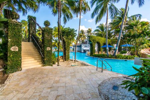 a staircase leading to a swimming pool with palm trees at Hilton Rose Hall Resort & Spa in Montego Bay