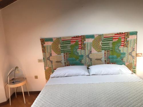 a bedroom with a bed with a large headboard at Camera con Vista in Brescia