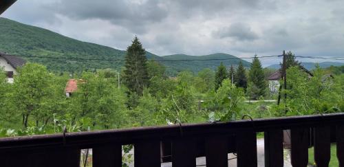 a balcony with a view of trees and mountains at Apartman & Sobe Orhideja in Smoljanac