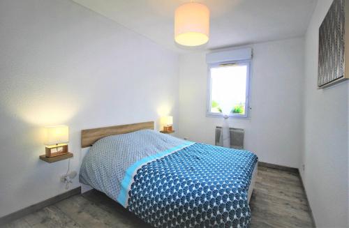 een slaapkamer met een bed met twee verlichting bij Tout confort ! Climatisation, Calme, Piscine, Parking Gratuit, Terrasse, Wifi in Carcassonne