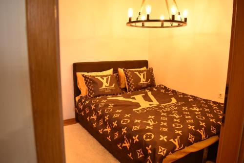 a bedroom with a bed and a chandelier at Naumovski Apartments in Skopje