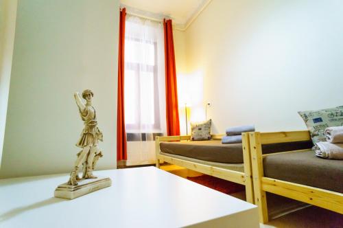 a room with two beds and a statue on a table at Budapest Kingdom Apartment CENTRAL & CAR PARKING ON-SITE & AIRCON & QUIET & FAMILY FRIENDLY in Budapest