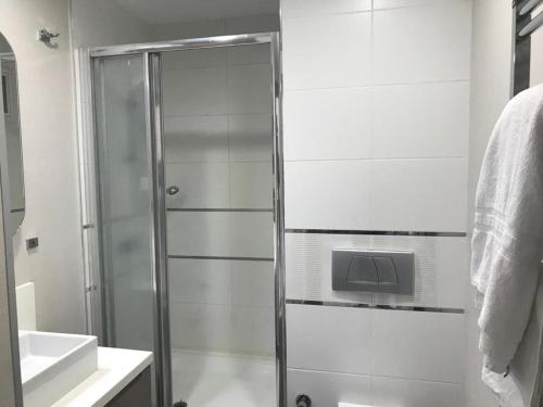 a shower with a glass door in a bathroom at Medıkule (7) 1+1 in Istanbul