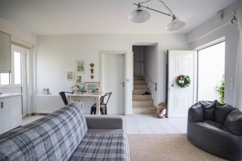 a living room with a couch and a table at Gaia apartments in Valimítika