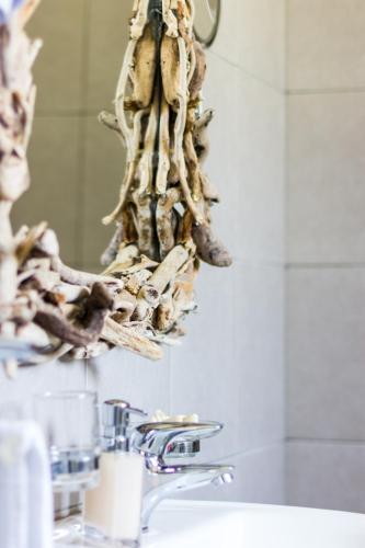 a bunch of bones hanging from a bathroom mirror at Gaia apartments in Valimítika