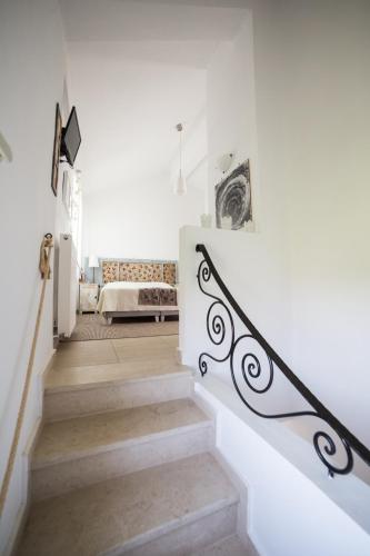 a staircase in a home with white walls at Gaia apartments in Valimítika