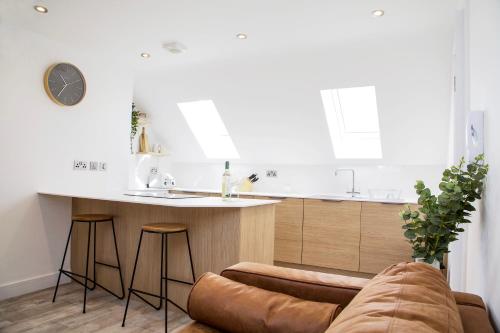 a kitchen with a couch and a counter in a room at The Barbershop Apartments in Manchester