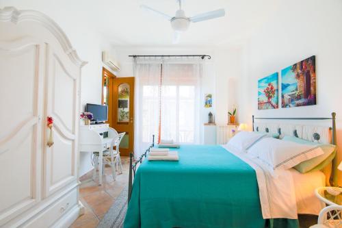 a bedroom with a bed and a desk in it at Costa Major in Maiori