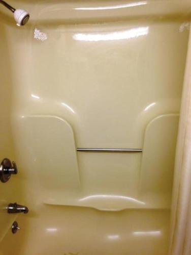 a close up of a shower door in a bathroom at Royal Inn Columbia/Fort Jackson in Columbia