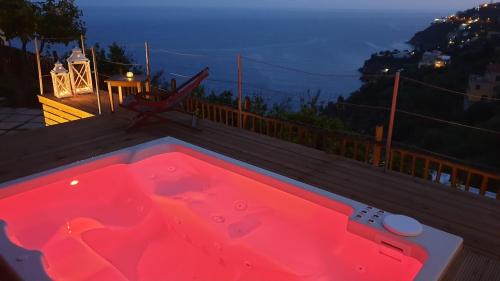 a red hot tub sitting on a deck at night at Villa Lauro Old Chapel in Amalfi