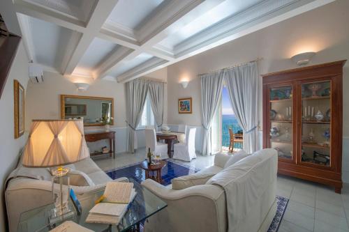a living room with couches and a table at Villa Lauro Old Chapel in Amalfi