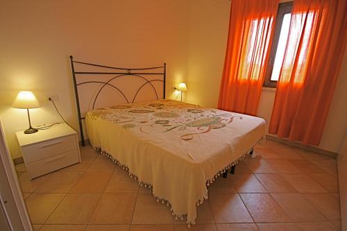 a bedroom with a bed and two windows at Myrsine in Murta Maria