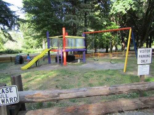 a playground with a slide in a park at Dean Creek Resort in Redway