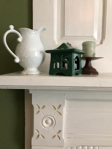 a shelf with a vase and other items on it at Magnolia House & Gardens B&B in Clover