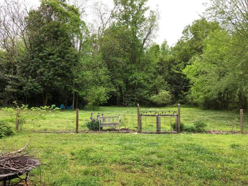 a garden with a gate in a field at Magnolia House & Gardens B&B in Clover