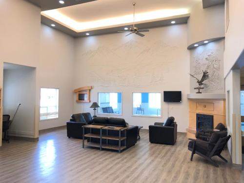 a living room with a couch and chairs and a fireplace at Ramada Golden in Golden